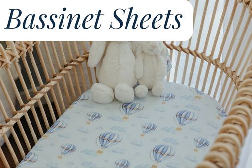 Jellycat Bunnies sitting in a bassinet